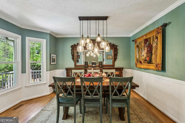 5876 Bridgemont Pl NW, Acworth, GA 30101 - dining space featuring a notable chandelier, wood finished floors, a textured ceiling, and visible vents