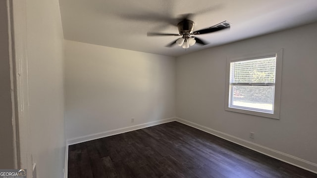 empty room featuring baseboards, a ceiling fan, and dark wood-style floors