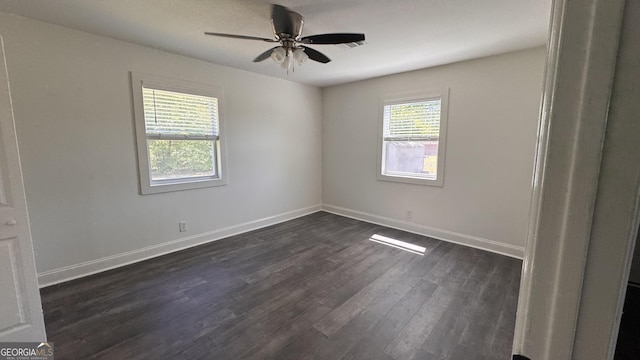 unfurnished room with visible vents, a ceiling fan, baseboards, and dark wood finished floors