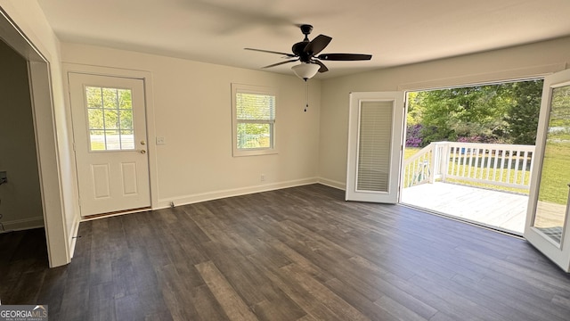 entryway featuring baseboards, a wealth of natural light, ceiling fan, and dark wood finished floors
