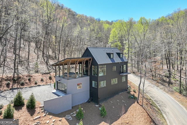 631 Bent Grass, Clayton, GA 30525 - view of front of home with a wooded view, metal roof, and a standing seam roof