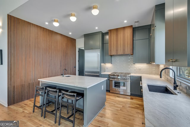 631 Bent Grass, Clayton, GA 30525 - kitchen with premium appliances, a sink, tasteful backsplash, a kitchen breakfast bar, and recessed lighting