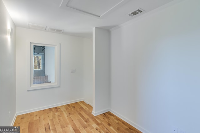 631 Bent Grass, Clayton, GA 30525 - spare room featuring attic access, light wood-style floors, and baseboards