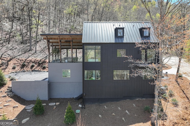 631 Bent Grass, Clayton, GA 30525 - view of home's exterior featuring metal roof and a forest view