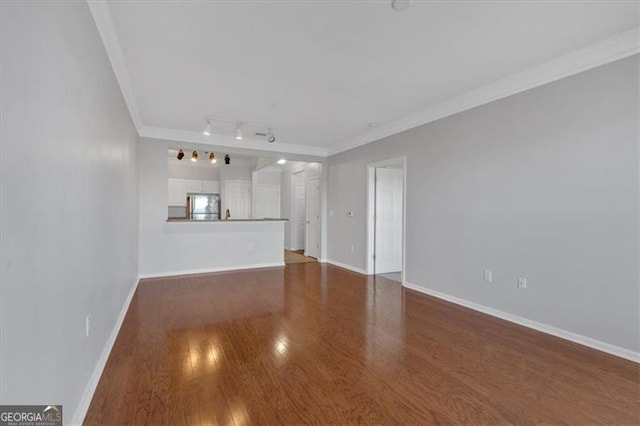 1850 Cotillion Dr Unit 4204, Dunwoody, GA 30338 - unfurnished living room with rail lighting, baseboards, ornamental molding, and wood finished floors