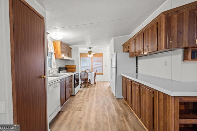 82 Dogwood Ct, Sparta, GA 31087 - kitchen featuring light countertops, white appliances, light wood-style floors, and ceiling fan