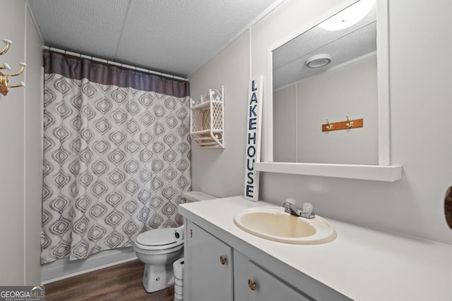 82 Dogwood Ct, Sparta, GA 31087 - full bath with a textured ceiling, toilet, shower / bath combo with shower curtain, wood finished floors, and vanity