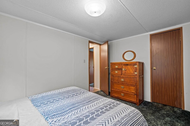 82 Dogwood Ct, Sparta, GA 31087 - carpeted bedroom featuring ornamental molding and a textured ceiling
