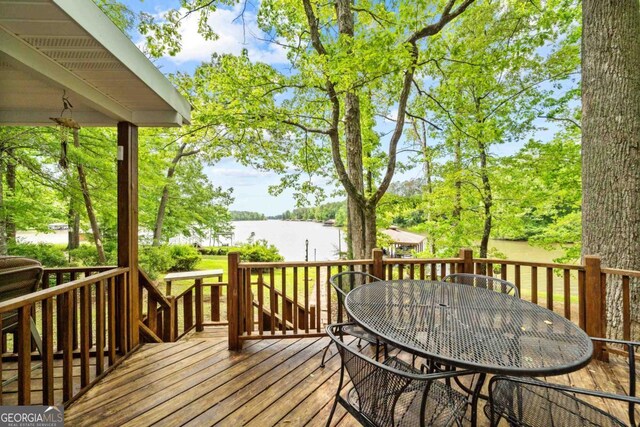 82 Dogwood Ct, Sparta, GA 31087 - wooden terrace featuring outdoor dining space and a water view