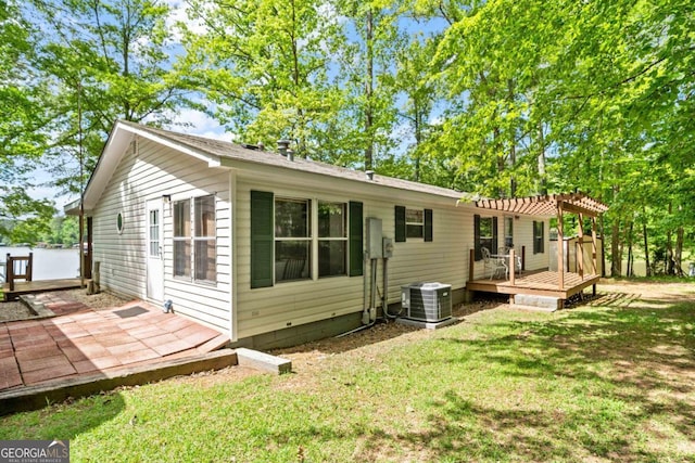 82 Dogwood Ct, Sparta, GA 31087 - back of house with a pergola, central air condition unit, a lawn, and a deck