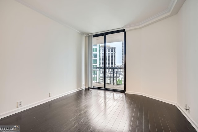 3481 Lakeside Dr NE Unit 1504, Atlanta, GA 30326 - unfurnished room with dark wood finished floors, baseboards, crown molding, and a wall of windows