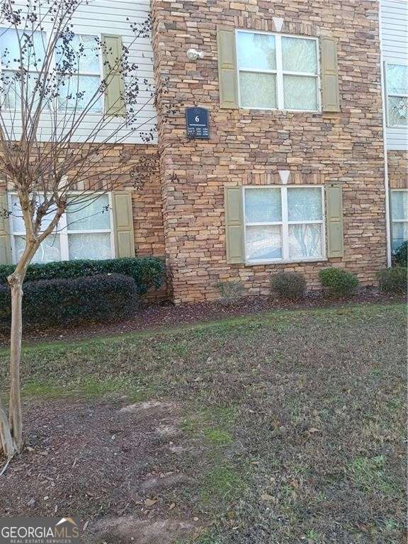 view of side of property with stone siding