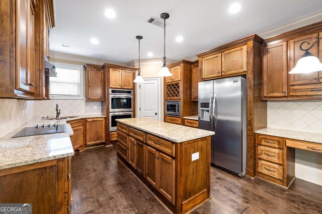 kitchen featuring a kitchen island, appliances with stainless steel finishes, decorative backsplash, and a sink