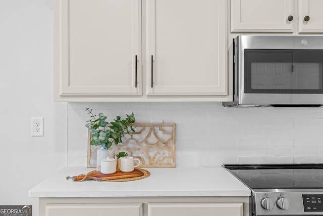 24 Hamilton Dr, Jefferson, GA 30549 - kitchen with decorative backsplash, light countertops, stainless steel microwave, and stove