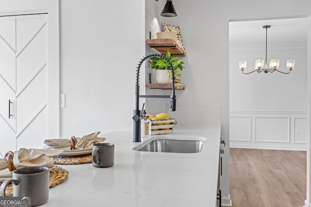 24 Hamilton Dr, Jefferson, GA 30549 - kitchen with a decorative wall, an inviting chandelier, a sink, and pendant lighting