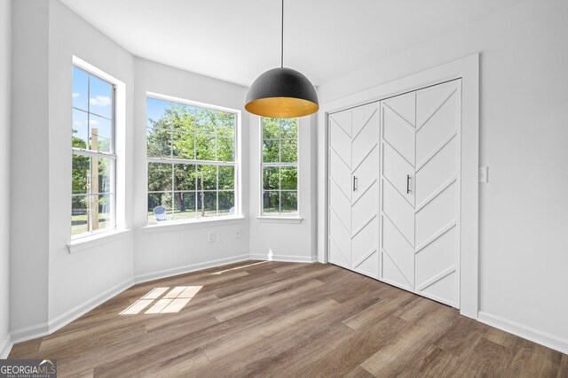 24 Hamilton Dr, Jefferson, GA 30549 - unfurnished dining area featuring baseboards, wood finished floors, and a healthy amount of sunlight