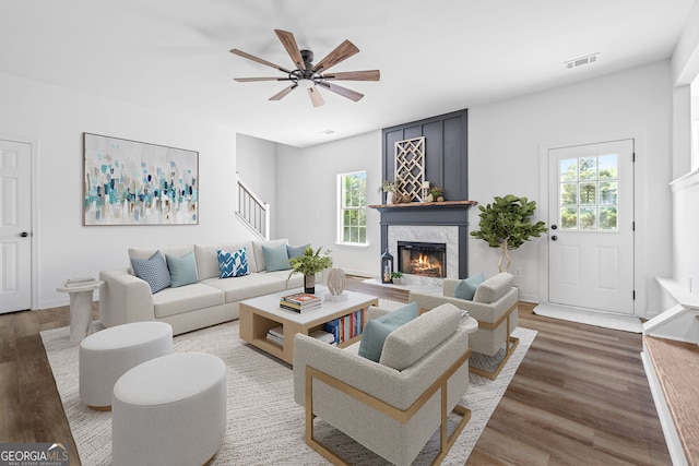 24 Hamilton Dr, Jefferson, GA 30549 - living area featuring wood finished floors, visible vents, a ceiling fan, a premium fireplace, and stairs