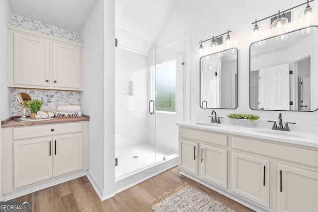 24 Hamilton Dr, Jefferson, GA 30549 - bathroom featuring lofted ceiling, wood finished floors, a sink, and a stall shower