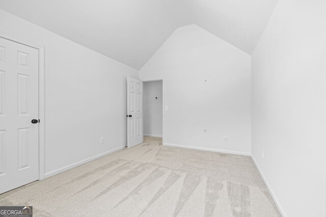24 Hamilton Dr, Jefferson, GA 30549 - unfurnished bedroom featuring light carpet, vaulted ceiling, and baseboards