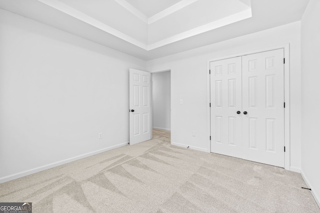 24 Hamilton Dr, Jefferson, GA 30549 - unfurnished bedroom featuring a raised ceiling, a closet, baseboards, and light carpet