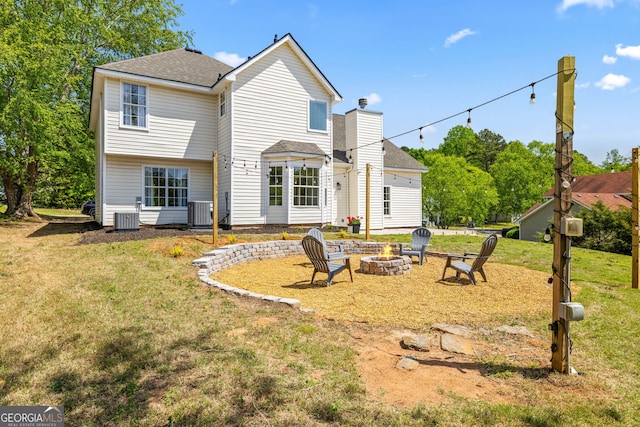 24 Hamilton Dr, Jefferson, GA 30549 - rear view of house with a lawn, a shingled roof, a fire pit, and central AC