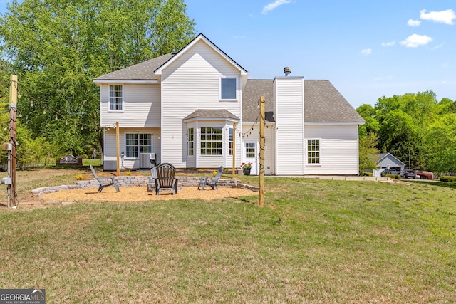 24 Hamilton Dr, Jefferson, GA 30549 - back of house with a yard, central air condition unit, a shingled roof, and a chimney