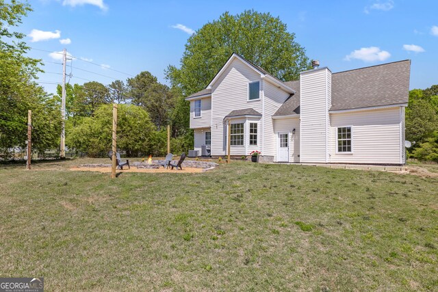 24 Hamilton Dr, Jefferson, GA 30549 - view of front of home with a fire pit, a chimney, a shingled roof, and a front yard