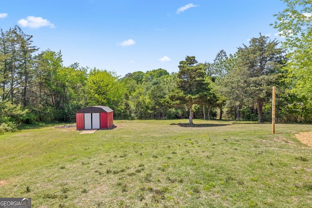 24 Hamilton Dr, Jefferson, GA 30549 - view of yard featuring an outdoor structure and a storage unit
