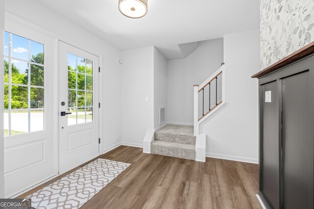 24 Hamilton Dr, Jefferson, GA 30549 - entrance foyer with visible vents, baseboards, wood finished floors, and stairs