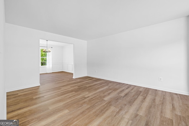 24 Hamilton Dr, Jefferson, GA 30549 - spare room featuring a chandelier and light wood-type flooring