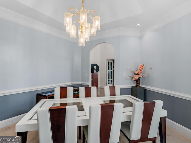carpeted dining room with crown molding, baseboards, recessed lighting, a chandelier, and arched walkways