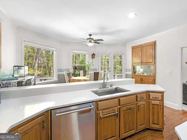 kitchen featuring a sink, a ceiling fan, dishwasher, and light countertops
