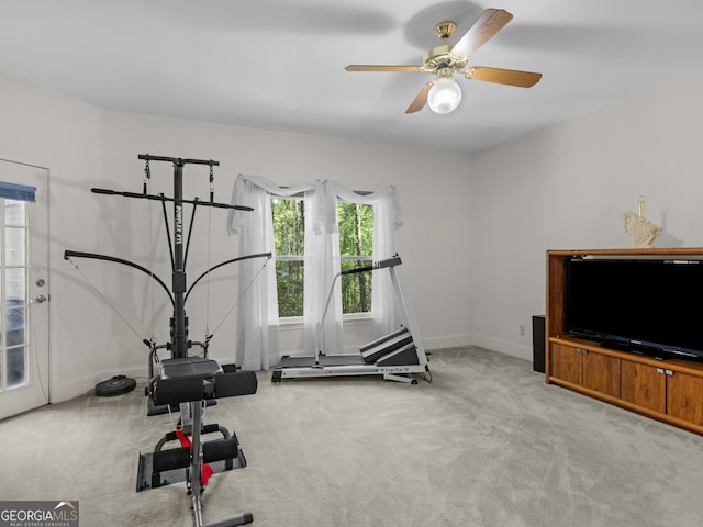 workout room featuring baseboards, carpet flooring, and a ceiling fan