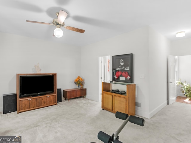 exercise area with visible vents, a ceiling fan, and light carpet