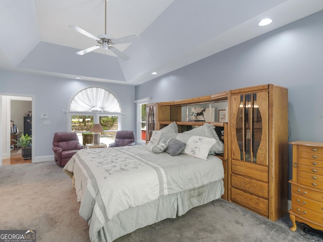 carpeted bedroom with a ceiling fan, baseboards, recessed lighting, and a raised ceiling