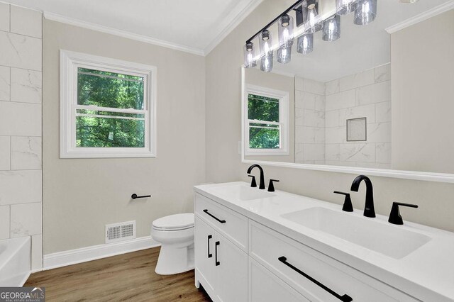 486 Edward Ct, Marietta, GA 30066 - full bathroom with crown molding, baseboards, toilet, wood finished floors, and a shower
