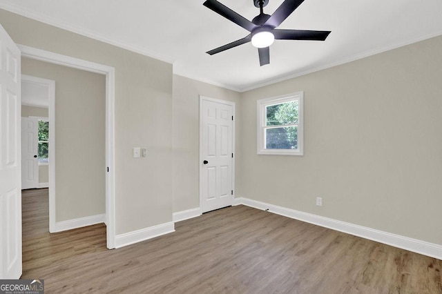 486 Edward Ct, Marietta, GA 30066 - unfurnished bedroom featuring wood finished floors, baseboards, crown molding, and ceiling fan