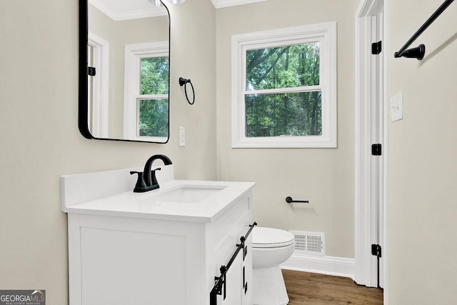 486 Edward Ct, Marietta, GA 30066 - bathroom with toilet, healthy amount of natural light, crown molding, vanity, and baseboards