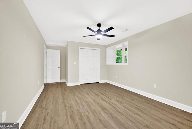 486 Edward Ct, Marietta, GA 30066 - unfurnished bedroom with wood finished floors, baseboards, a closet, and a ceiling fan