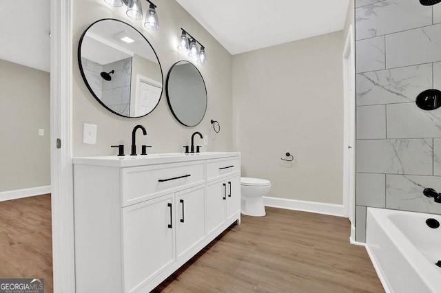 486 Edward Ct, Marietta, GA 30066 - bathroom featuring baseboards, toilet, wood finished floors, and double vanity