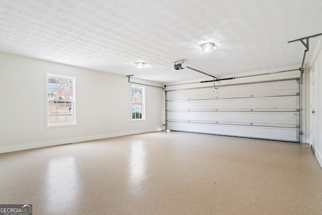 115 Stewart Hollow Ln, Covington, GA 30016 - garage featuring baseboards and a garage door opener