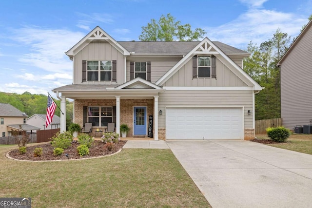 craftsman-style house with driveway, a porch, fence, an attached garage, and board and batten siding