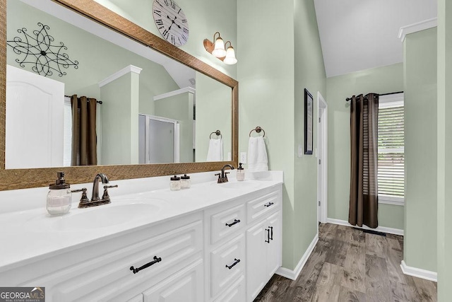 full bathroom with lofted ceiling, baseboards, and a sink