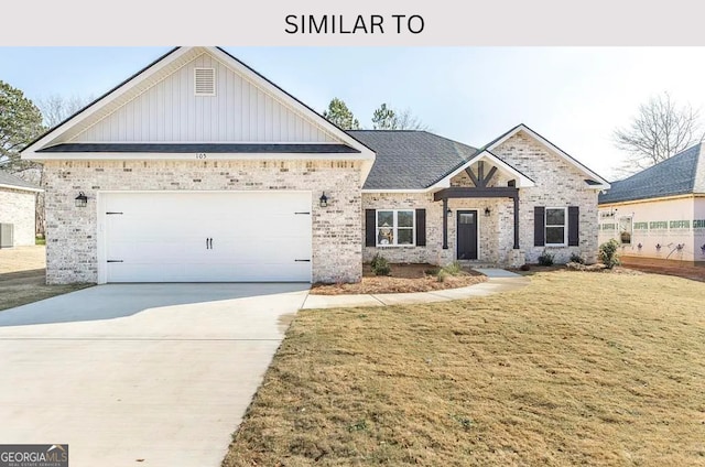 104 Reedy Ct, Perry, GA 31069 - view of front of property with board and batten siding, brick siding, a front lawn, driveway, and a garage