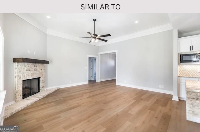 104 Reedy Ct, Perry, GA 31069 - unfurnished living room with a brick fireplace, a ceiling fan, ornamental molding, light wood finished floors, and recessed lighting