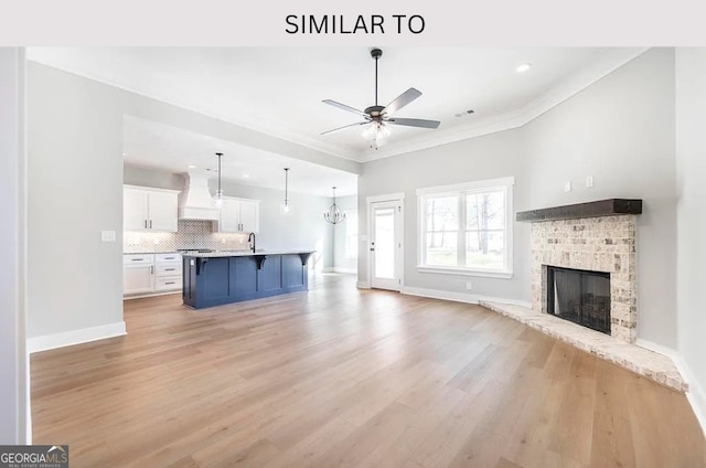 104 Reedy Ct, Perry, GA 31069 - unfurnished living room with ceiling fan, a fireplace, light wood-style flooring, recessed lighting, and ornamental molding