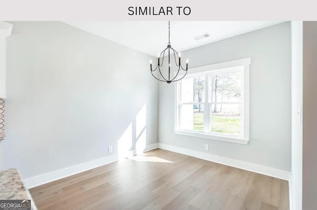104 Reedy Ct, Perry, GA 31069 - unfurnished dining area featuring a chandelier and wood finished floors