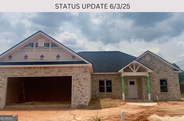 104 Reedy Ct, Perry, GA 31069 - property under construction featuring brick siding, a garage, driveway, and roof with shingles