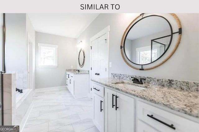 104 Reedy Ct, Perry, GA 31069 - full bathroom with marble look tiles, two vanities, and a bath