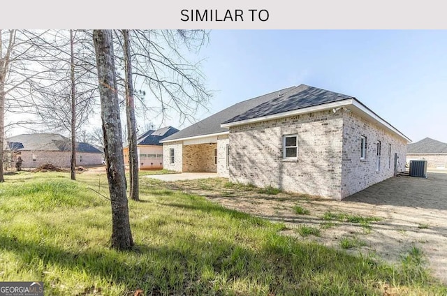 104 Reedy Ct, Perry, GA 31069 - view of side of property featuring brick siding, roof with shingles, and a lawn
